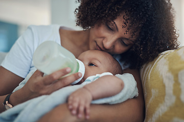 Image showing Care, woman feeding her baby with bottle and in living room on the sofa at their home. Family love, drinking or nutrition and black mother feed her newborn child on couch of their house with formula