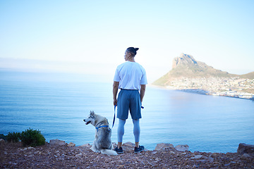 Image showing Nature, lake and man with dog in mountain for hiking, walking and fresh air together outdoors. Traveling, friendship and back of male person with pet husky relax for freedom, adventure and exercise