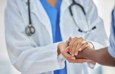 Image showing Doctor, holding hands and patient with support, help and grief consulting after cancer news. Hospital, healthcare and clinic worker with person supporting with guidance and advice from health results