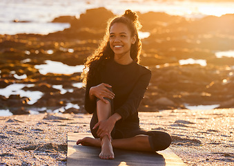 Image showing Sunset, woman with yoga mat and at beach happy with a lens flare. Fitness or exercise, meditation or freedom and female person relax with smile for health wellness with sunlight outdoors for peace