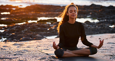 Image showing Woman, beach yoga and sunset with lotus, eyes closed and peace of mind in summer sunshine. Girl, zen meditation and mindfulness for health, wellness and exercise by ocean, chakra balance and energy