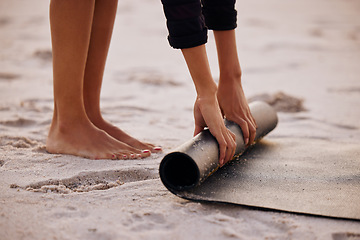 Image showing Woman, yoga and beach with hand and feet for rolling mat with clean wellness or fitness. Female person, meditation and yogi on seashore with hands in the outdoor for start in the morning and pilates.