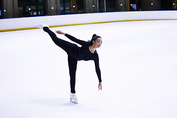 Image showing Sport, woman athlete figure skating and at a sports arena on ice floor. Fitness training or exercise, balance or health wellness and female person skate for competition or tournament in sportswear