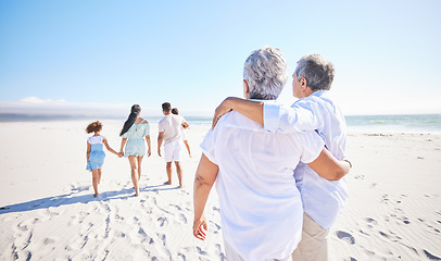 Image showing Big family, sea or old couple walking with children in summer with happiness, trust or peace in nature. Grandparents, back view or senior man bonding with woman or kids taking a walk on beach sand