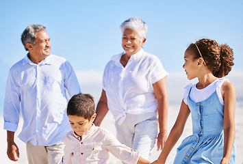 Image showing Beach, grandparents or happy kids holding hands, walking or smiling in summer as a family in nature. Grandmother, senior grandfather or young children siblings bonding or taking walk together at sea