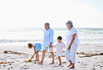 Image showing Beach, grandparents or happy children holding hands, walking or smiling as a family in nature. Grandmother, senior grandfather or young kids siblings bonding or taking walk together at sea