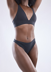 Image showing Body, fitness and beauty with black woman in studio for nutrition, weight loss and diet. Health, wellness and abdomen muscle with closeup of female model on white background for self care and glow