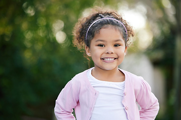 Image showing Happy, smile and portrait of a kid in a garden with joy, positive emotion and childhood growth. Happiness, excited girl and face of cute child from Mexico standing outdoor in park with mockup space