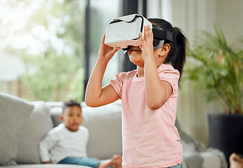 Image showing Young girl with VR goggles, gaming and metaverse with futuristic tech, child experience simulation at family home. Female kid in living room with video games, virtual reality and future technology