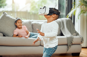 Image showing Young boy with VR goggles, gaming and metaverse with futuristic tech, child experience simulation at family home. Male kid in living room with video games, virtual reality and future technology