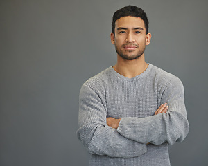 Image showing Portrait of man in studio with mockup space, arms crossed and confident smile on studio backdrop in casual fashion. Relax, confidence and face of male on grey background with focus, pride and mock up