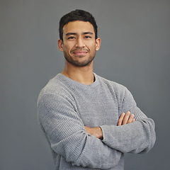 Image showing Portrait of happy man with mockup, arms crossed and ideas on studio backdrop in casual fashion. Relax, confidence and face of male on grey background with happiness, pride and smile with promo space.