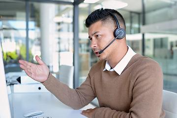 Image showing Man, callcenter with phone call and CRM, contact us and communication with headset in office. Male consultant in customer service, telemarketing or tech support with help desk job, advice and telecom