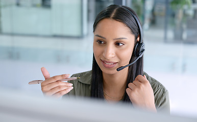 Image showing Woman, phone call at callcenter with CRM and contact us, communication with headset and technology in office. Female consultant in customer service, telemarketing or tech support with help desk job