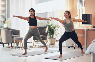 Image showing Friends, yoga and women exercise together in a house for health, balance or wellness. Happy Indian sisters or female family in a home for stretching workout, warrior pose and fitness with a partner