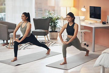 Image showing Women, yoga and friends exercise in a house together with smile, health and wellness. Indian sisters or female family in a lounge while happy about workout, stretching and fitness with a partner