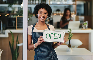 Image showing Happy woman, open sign and portrait at cafe of waitress or small business owner for morning or ready to serve. African female person at restaurant holding board for coffee shop or cafeteria opening