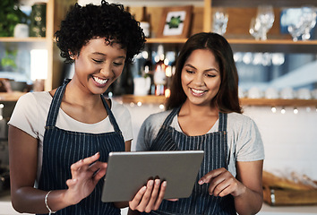 Image showing Happy woman, tablet and waitress in teamwork at cafe for inventory, checking stock or orders at restaurant. Barista women or small business team working on technology at coffee shop in online service