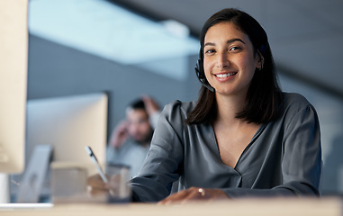 Image showing Call center, portrait and woman writing notes for customer service, sales consulting and CRM in office at night. Happy female agent, consultant and contact us for telemarketing, online help or advice