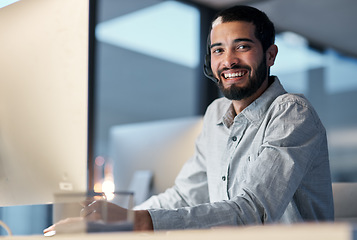 Image showing Call center, happy man and portrait at computer for customer service, telemarketing sales and CRM consulting at night. Male agent, desktop pc and smile for communication, advice and technical support