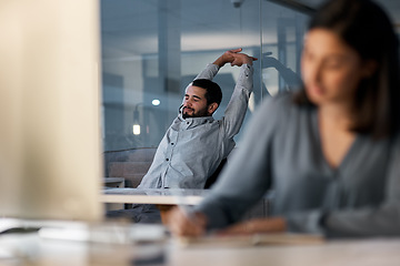 Image showing Call center, tired man and stretching at computer desk for telemarketing support in coworking office at night. Lazy, sleepy and frustrated male agent with burnout, fatigue and bored of consulting