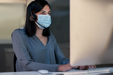 Image showing Call center, woman and face mask at computer for customer service, telemarketing sales and CRM consulting in office. Female agent, desktop and covid safety for online telecom advice, support and help