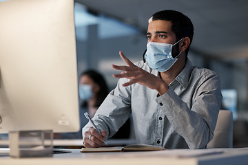 Image showing Call center, man and communication with mask at computer while writing notes for advice, customer service and sales. Male telemarketing agent, virus protection and desktop for consulting questions