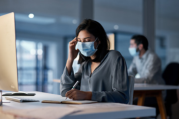 Image showing Call center, woman and notebook at computer with mask for customer support, sales and CRM consulting at night. Female agent, telemarketing and virus protection on face in office for administration