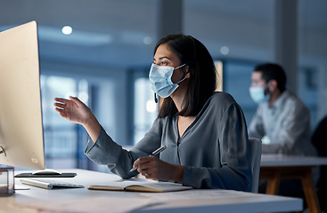 Image showing Call center, woman and mask at computer for customer service, telemarketing notes and CRM consulting at night. Female agent, desktop and virus protection for online support, questions and help desk