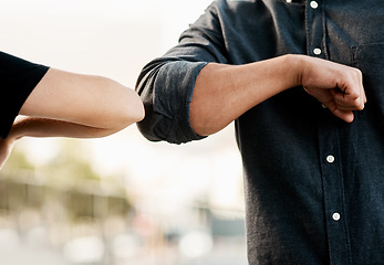 Image showing Closeup, man and woman elbow greeting to avoid the spread of coronavirus or COVID-19 infection and outdoors. Social distancing, health and wellness or fear of pandemic or meet in the street outside