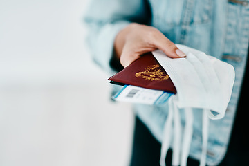 Image showing Covid, person and hands with passport, face mask and protection for boarding pass at airport. Closeup, travel and tourists journey of passenger with personal visa for safety, security or safeguarding