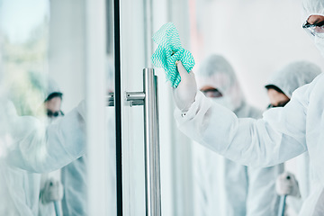 Image showing Covid disinfection, cleaning hospital window with cloth and healthcare compliance for safety and hygiene. Disinfecting glass, people in PPE for protection from corona virus with medical policy