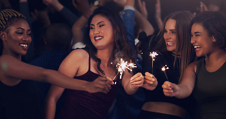 Image showing Sparkler, party and night with women in club for music, celebration and nightlife concert. Festival, disco and happy hour with friends dancing in crowd at social event for energy, techno and dj show