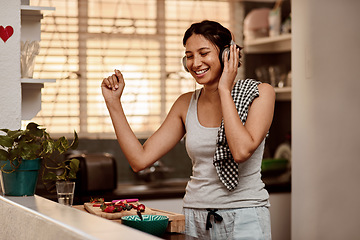 Image showing Music headphones, dancing and woman cooking with fruit, strawberry and food. Dance, headphone and female person making breakfast while listening to audio, sound and radio podcast in happy kitchen.