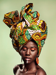 Image showing Beauty, black woman and queen makeup with African head wrap and pride with fashion. Isolated, green background and young female person with a traditional hair scarf with confidence and culture