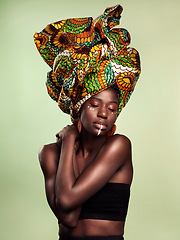 Image showing Beauty, black woman fashion and cosmetics with African head wrap and makeup in studio. Isolated, green background and young female person with a traditional hair scarf with confidence and culture