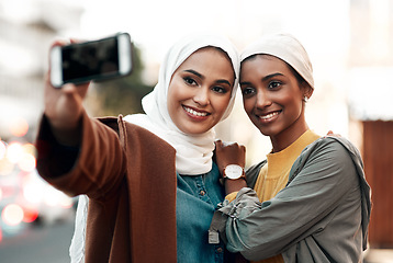 Image showing Muslim woman, selfie and social media in city together with happiness, outdoor or urban adventure. Islamic women, profile picture and photography for travel blog, app and friends on road in metro cbd