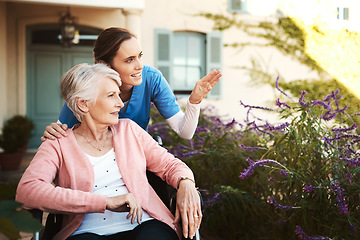 Image showing Senior woman, wheelchair and nurse in garden pointing and talking on walk in healthcare support at nursing home. Happy elderly female or caregiver showing patient or person with a disability outdoors