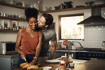 Image showing Interracial couple, kiss and hug in kitchen for cooking, morning breakfast, love or caring relationship at home. Man kissing woman preparing food, meal or cutting ingredients on table at the house