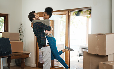 Image showing Happy interracial couple hug in new home for property relocation, renovation or investment together. Excited man embrace woman in real estate, house and boxes for moving, mortgage loan or celebration