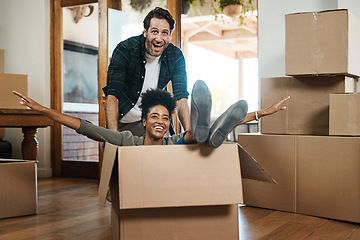 Image showing Happy couple, box and real estate in new home or property for renovation and investment together. Excited interracial man, woman and playing in boxes, moving to house or celebration of fun relocation