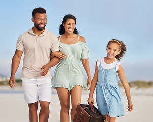 Image showing Happy family, parents or girl walking on beach to relax on fun holiday vacation or picnic together. Dad, mom or excited young child bonding, smiling or holding basket outdoors in summer at seashore