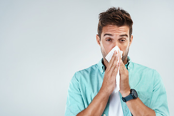 Image showing Wipe nose, tissue and portrait of man in studio with flu allergy, sickness and virus on white background. Handkerchief, mockup space and face of male person for hayfever, cold and sneeze for sinus