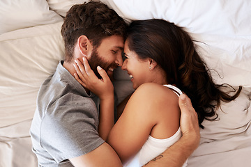 Image showing Smile, bed and happy couple hug, relax and spending lazy morning together, bonding and intimacy on Spain vacation. Happiness, marriage and top view of romantic man, woman or people embrace in bedroom