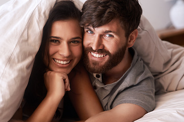 Image showing Bed blanket, face and portrait of happy couple, relax and enjoy morning together bonding on Croatia vacation holiday. Happiness, smile and romantic woman, man or people resting in home bedroom