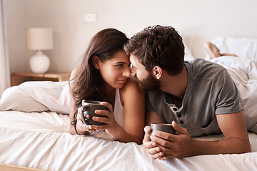 Image showing Home bedroom, coffee and couple bonding, relax and enjoy morning latte, espresso or beverage drinks. Forehead, marriage or romantic man, woman or people with tea cup, love and affection in hotel bed