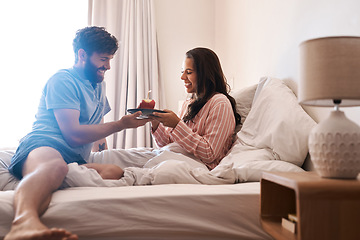 Image showing Happy couple, bedroom and birthday muffin, morning dessert or celebration food for excited woman. Cupcake candle, surprise sweets and fun people smile, happiness and celebrate special day on home bed