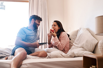 Image showing Couple, bedroom and eating birthday cupcake, surprise candy dessert or celebration sweets on Italy holiday. Breakfast muffin, morning food or woman hungry, relax and celebrate special day on home bed