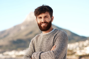 Image showing Nature portrait, arms crossed and happy man relax with outdoor wellness, vacation freedom and smile for peace. Summer sunshine, mountain and male person on travel holiday in Cape Town, South Africa