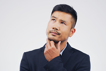 Image showing Thinking, doubt and an Asian businessman with ideas isolated on a white background in a studio. Idea, space and a corporate employee with a choice, decision or planning a question on a backdrop